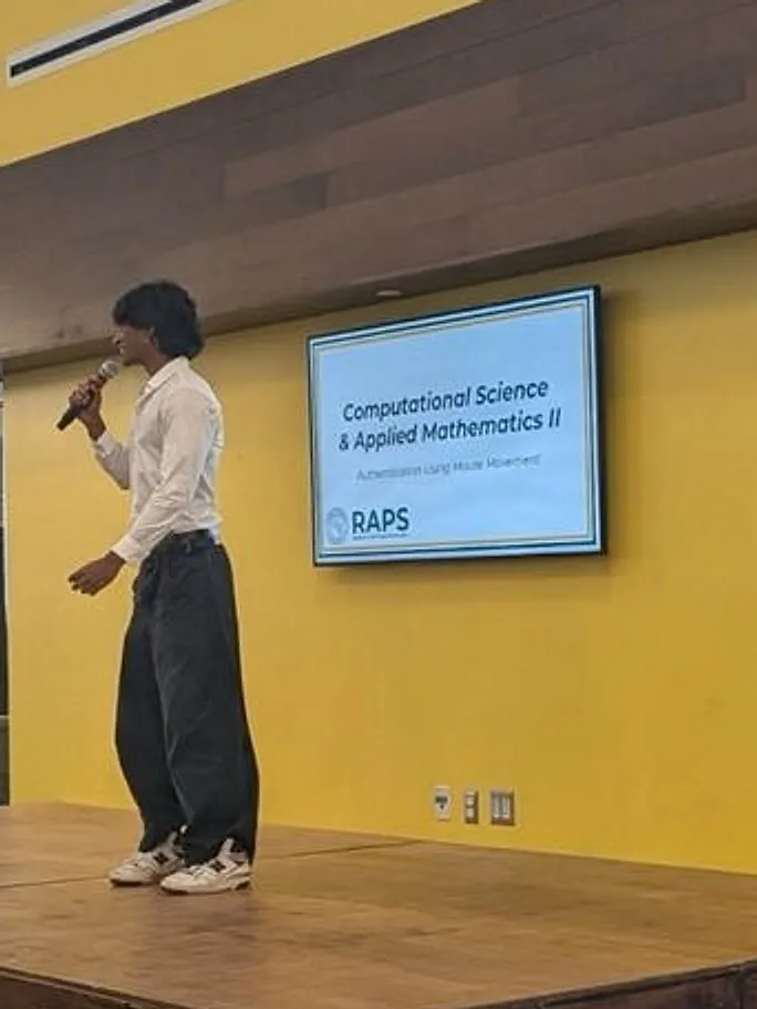 Sahil presenting Authentication Using Mouse Movement on stage at Clarkson University's RAPS showcase